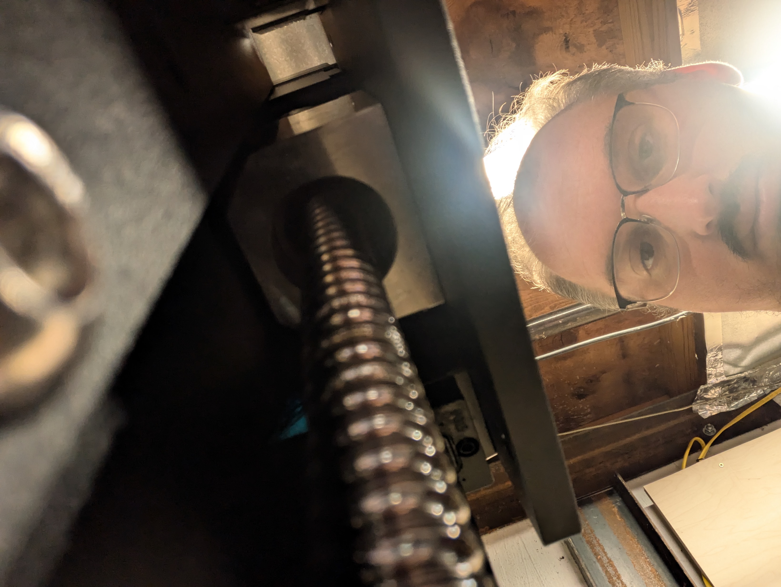Andrew inspecting his CNC machine in the shop